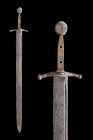 MEDIEVAL IRON SWORD

 Ca. 1100-1200 AD
 A forged-iron sword with a slender hand guard and a discoid pommel. The cross-style two guard has a slight ...