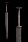 LATE MEDIEVAL IRON RONDEL DAGGER / STILETTO

 Ca. 1400-1500 AD
 An iron dagger or stiletto featuring a double-edged slender blade with a button-sha...