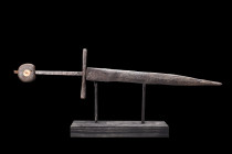 MEDIEVAL IRON DAGGER WITH DISC-SHAPED POMMEL

 Ca. 1300-1500 AD
 An iron double-edged dagger with a straight sculptured cross guard with incised de...