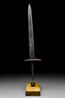 LATE MEDIEVAL LONG DAGGER WITH OFF SQUARE POMMEL

 Ca. 13th-15th century AD
 A long iron dagger with a slender blade tapering to a point, a short c...