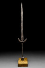 MEDIEVAL SHORT SWORD WITH SQUARE POMMEL

 Ca. 13th-15th century AD
 An iron short sword featuring a slender blade tapering to a point, with an acut...