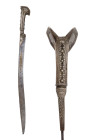 A TURKISH ISLAMIC SILVER-MOUNTED YATAGAN SWORD WITH GOLD INLAY

 Ca. 19th century AD
 With a characteristic form eared silver hilt decorated with r...