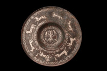 TIMURID BRONZE SILVER INLAY PLATE

 Ca. early 14th century AD
 A bronze plate of a shallow form features a circular recess in the center, which is ...