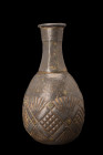 ISLAMIC DECORATED LEAD BOTTLE

 Ca. 15th century AD
 A bronze bottle or flask with a pear-shaped lower body and flat base, a neck with a facetted p...