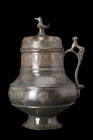 SELJUK BRONZE EWER

 Ca. 1100-1200 AD
 An ewer, imbued with timeless grace and beauty. This exquisite piece stands proud on its flaring, concave fo...