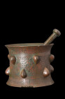 KHORASAN BRONZE DECORATED MORTAR

 Ca. 1150-1200 AD
 A cast bronze mortar and pestle of tubular form, with a flaring bottom and upper flange that g...