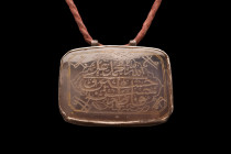 ISLAMIC STONE AND SILVER PENDANT

 Ca. 17th-19th century AD
 A rectangular-shaped pendant with a carved stone at the center stage, elevated in a si...