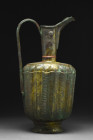 KHORASAN EWER

 Ca. 12th century AD
 A large ewer, crafted with remarkable skill and precision. Its cylindrical body is adorned with intricate ribb...