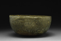 ISLAMIC DECORATED BRONZE BOWL

 Ca. 10th-11th century AD
 A bronze bowl characterized by a deep body, rounded base, and high sides. The bowl's inte...