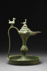 SELJUK BRONZE OIL LAMP WITH BIRDS

 Ca. 1100-1200 AD
 A bronze oil lamp displaying intricate openwork, a domed lid with a bird finial, and trefoil-...