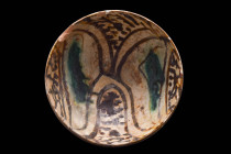 DECORATIVE SAMANID BOWL WITH SPLASHWARE ELEMENTS

 Persia, Ca. 11th-12th century AD
 A ceramic deep bowl with wide, flaring sides and a low disc fo...
