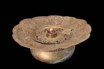 QAJAR BRASS BASIN

 Ca. 19th century AD
 A brass ablution basin formed from brass and takes on a squat, globular shape with a widely flaring rim. T...