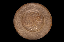 ISLAMIC DECORATED PLATE

 Ca. 17th-19th century AD
 A shallow plate of a circular shape boasts an intricate design, with the central well and wide ...