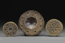 ISLAMIC GROUP OF THREE BRASS WEIGHTS/MOULDS

 Ca. 16th -18th century AD
 A group of three brass weights/molds used in plasterwork or baking, each c...