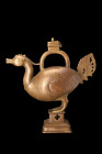 INDIAN BRASS HAMSA AQUAMANILE

 Deccan, ca. 16th-18th century AD
 An aquamanile, crafted in the form of a hamsa bird - a symbol of great cultural s...