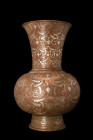 ISLAMIC VASE WITH SILVER INALYS

 Ca. 17th-19th century AD
 A brass vase features a low flared foot, a globular body, and a neck of funnel-shape. T...
