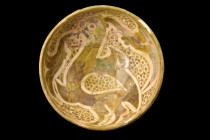 ABBASID POTTERY BOWL WITH A BIRD

 Ca. 1000-1100 AD
 A pottery bowl, that embodies the intricate beauty and sophistication of Islamic art. Its coni...