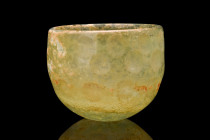 EARLY ISLAMIC CUT GLASS BOWL

 Ca. 600-700 AD
 A cut glass bowl of a hemispherical shape, complemented by a concave base, creates a well-balanced a...