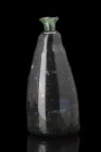 GREEN GLASS CONICAL SADDLE BOTTLE

 Ca. 17th-18th century AD
 A beautifully coloured green glass saddle bottle with a conical-shaped body, short fl...