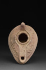 ISLAMIC CLAY EPIGRAPHIC OIL LAMP

 Levant or Iraq, Ca. 13th-14th century AD
 A clay teardrop-shaped oil lamp with a central filling hole framed wit...