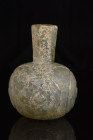 ISLAMIC DECORATED GLASS BOTTLE

 Ca. 900-1000 AD
 A glass bottle with a captivating allure with its apple-shaped lower body, elegantly crafted upon...