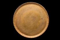 ISLAMIC DECORATED BRASS TRAY

 Ca. 17th-19th century AD
 A circular tray, crafted from brass with a flat base, intricately chiseled sides and encha...