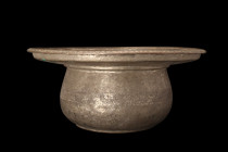 QAJAR TINNED COPPER BASIN

 Ca. 19th century AD
 A tinned copper basin boasting a broad profile, with a flat base and a graceful body that opens up...