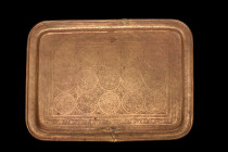 ISLAMIC DECORATED BRASS TRAY

 Ca. 17th-19th century AD
 A brass tray of a rectangular shape with a reinforced rim, which adds to the sturdy and el...