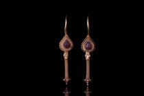 PARTHIAN GOLD PAIR OF EARRINGS

 Ca. 2nd century AD
 A matched pair of gold earrings. These earrings are a breathtaking sight, with each hoop metic...