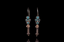 PARTHIAN GOLD PAIR OF EARRINGS

 Ca. 2nd century AD
 A pair of matched earrings made of gold. Each earring boasts a hoop, attached to a four-compar...