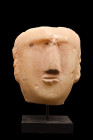 SOUTH ARABIAN ALABASTER FACE STELE

 Ca. 200 BC - 100 AD
 A hand-carved alabaster head of a man delineated in high relief, perhaps from a funerary ...