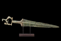 BRONZE AGE BRONZE SWORD WITH RESTORED HANDLE

 Ca. 2nd millennium BC
 A bronze sword . This double-edged weapon boasts a sharp blade that tapers to...
