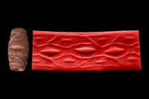 MESOPOTAMIAN STONE CYLINDER SEAL - ORIGINAL LAMBERT REPORT

 Ca. 3000 BC
 Cylinder seal of brown stone. A frieze of wavey lines enclosing two big "...