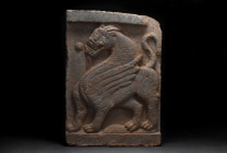 CHINESE HAN DYNASTY STONE RELIEF WITH DRAGON

 Ca. 202 BC-220 AD
 A beautiful rectangular stone relief depicting a dragon in left profile with a hi...