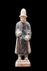 CHINESE MING DYNASTY GLAZED TERRACOTTA ATTENDANT

 Ca. 1368-1644 AD or later 
 A glazed terracotta mingqi depicting a standing attendant on a tiere...