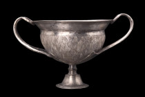 ROMAN SILVER SKYPHOS

 Ca. 1st century BC - 1st century AD
 Skillfully fashioned from high-quality silver, this exceptional skyphos features a hemi...
