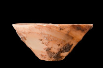 EGYPTIAN ALABASTER BOWL

 Old Kingdom, ca. 2686-2160 BC
 This cone-shaped bowl, expertly carved from alabaster, boasts a wide opening, circular and...