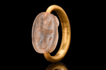 PHOENICIAN GOLD RING WITH ROCK CRYSTAL SCARABOID

 Ca. 7th-6th century BC
 A gold ring made of gleaming gold, expertly crafted into a D-shaped shan...