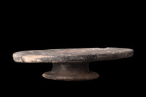 CAMPANIAN FOOTED POTTERY PLATE

 Ca. 400 BC
 A terracotta black slipware dish with a short circular foot base and a wide, flat cavity. This unassum...