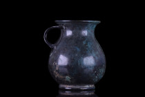 SUPERB ROMAN BRONZE OLPE - GREAT PATINA

 Ca. 100-300 AD
 A bronze olpe rising from a ring foot. The vessel features a globular lower body tapering...