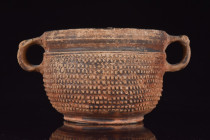 RARE ROMAN POTTERY SKYPHOS

 Ca. 100 BC - 100 AD
 The mold-made body is decorated with a pine-cone or petal-like motif, with a smooth foot, rim, an...