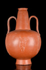 NORTH AFRICAN TERRA SIGILLATA BOTTLE

 Ca. 300-400 AD
 A fine redware jug, with a rounded body and applied decoration including a youthful Bacchus ...