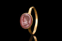 ROMAN GOLD RING WITH CARNELIAN PORTRAIT INTAGLIO 

 Ca. 200-300 AD
 A gold finger ring with a carnelian portrait intaglio is a stunning example of ...