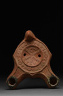 ROMAN RED WARE DOUBLE SPOUTED OIL LAMP WITH CHI-RHO

 Ca. 300-400 AD
 A mold-made pottery lamp with rich, deep red color, especially around the noz...