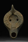 ROMAN TERRACOTTA OIL LAMP WITH BIRD ON A COLUMN

 North Africa, Ca. 300-600 AD
 A dark slip terracotta oil lamp depicting a right-faced bird standi...