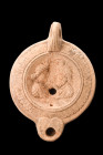 EASTERN ROMAN BEIGE TERRACOTTA OIL LAMP WITH ISIS AND SERAPIS BUSTS

 Eastern Roman art, ca. 2nd - 3rd century
 A light terracotta oil lamp featuri...