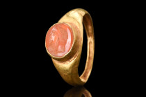 ROMAN GOLD RING WITH CARNELIAN JUPITER PORTRAIT INTAGLIO 

 Ca. 200 - 300 AD
 A gold finger ring with a carnelian portrait intaglio features one of...