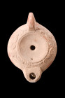 ROMAN TERRACOTTA OIL LAMP WITH MAKER'S MARK

 Ca. 1-100 AD
 A terracotta oil lamp, Loeschcke VIII type, is a remarkable example of functional and d...