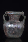 ROMAN GLASS JAR WITH HANDLES

 Ca. 300 AD
 Ca. 300 AD. Translucent green; handles in the same color. Outsplayed rim, folded over and in, and smooth...