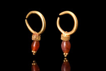 ROMAN GOLD EARRINGS WITH CARNELIAN BEADS

 Ca. 100-300 AD
 A charming matched pair of gold earrings with carnelian beads. At the heart of these ear...